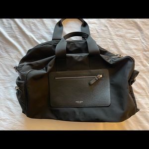 Giorgio Armani mens nylon waterproof black duffel bag.